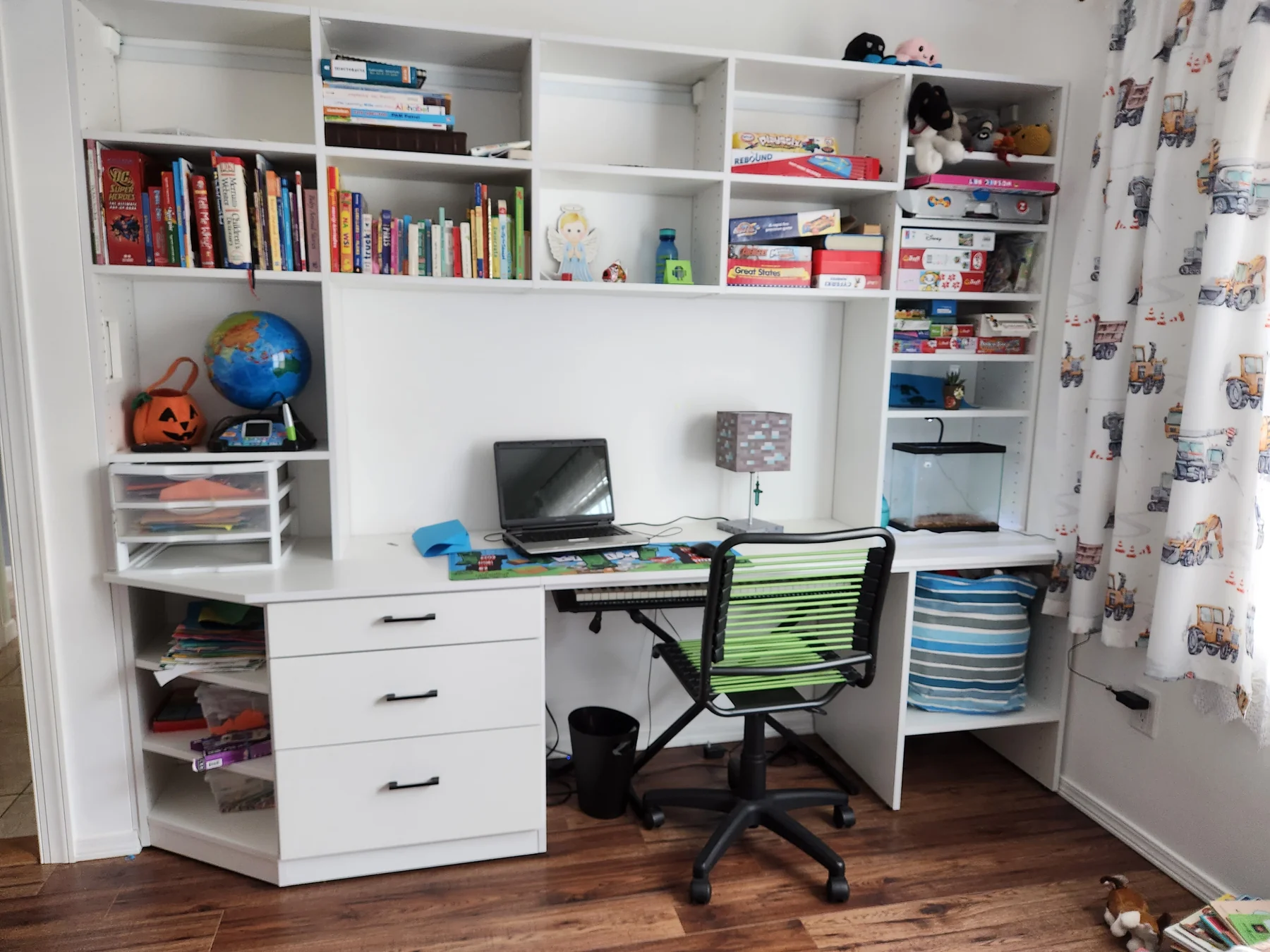 Angled view of a white study wall with a wood-accented desk and shelving