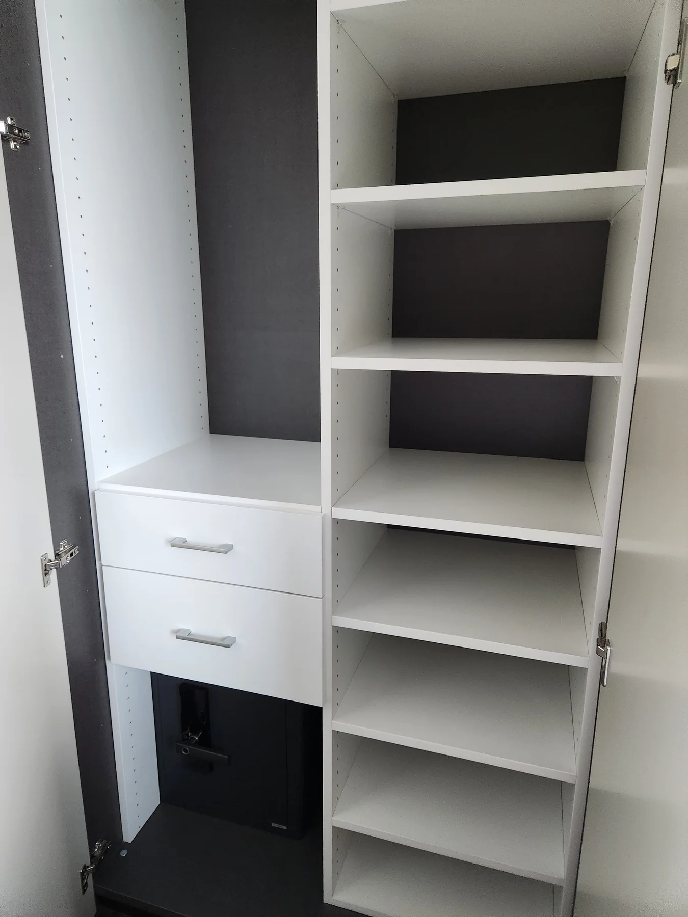 White closet interior with drawers, hanging space and adjustable shelves