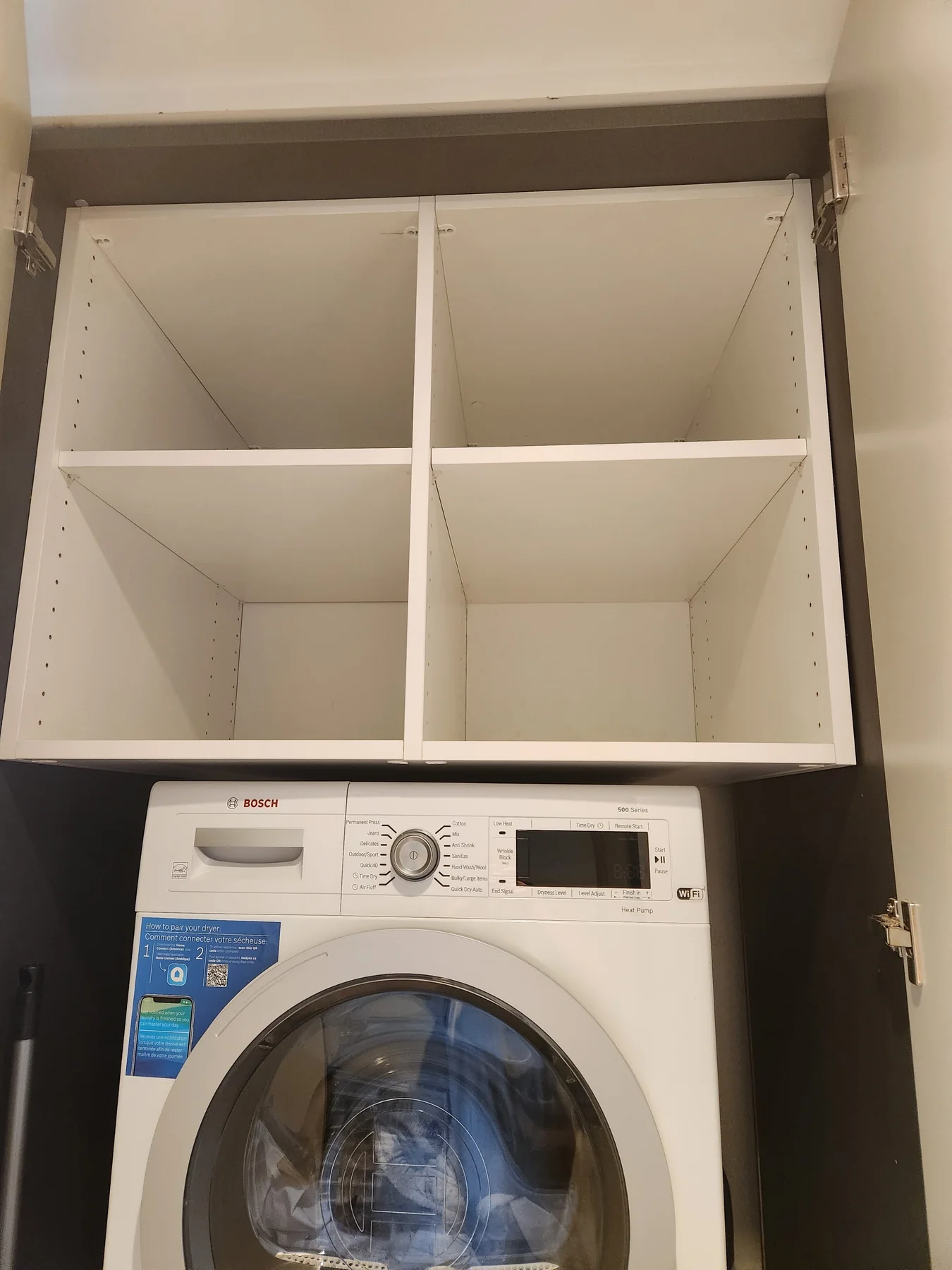 White open laundry shelves above a washing machine