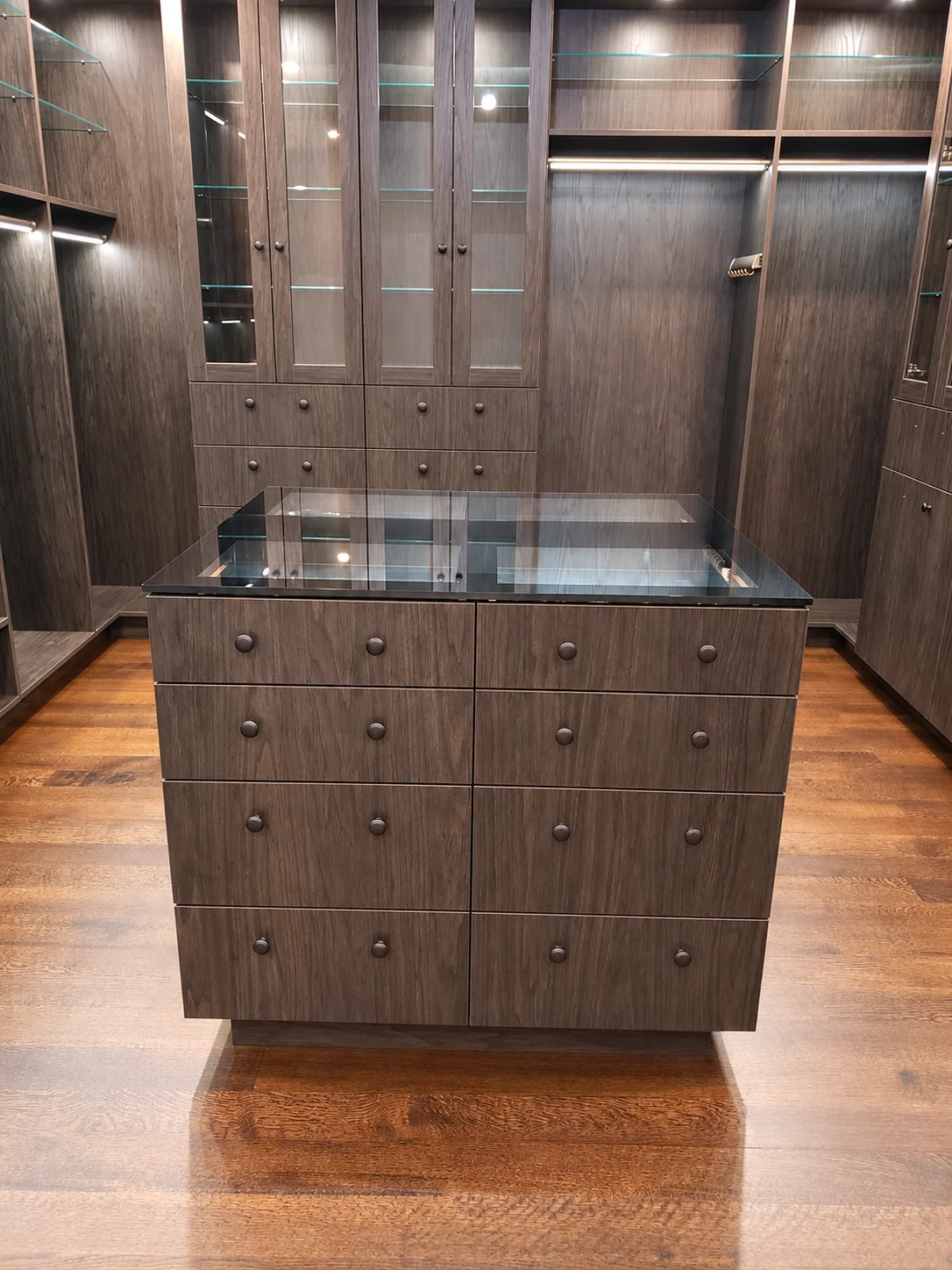 Glass-top closet island with eight drawers and matching round knobs