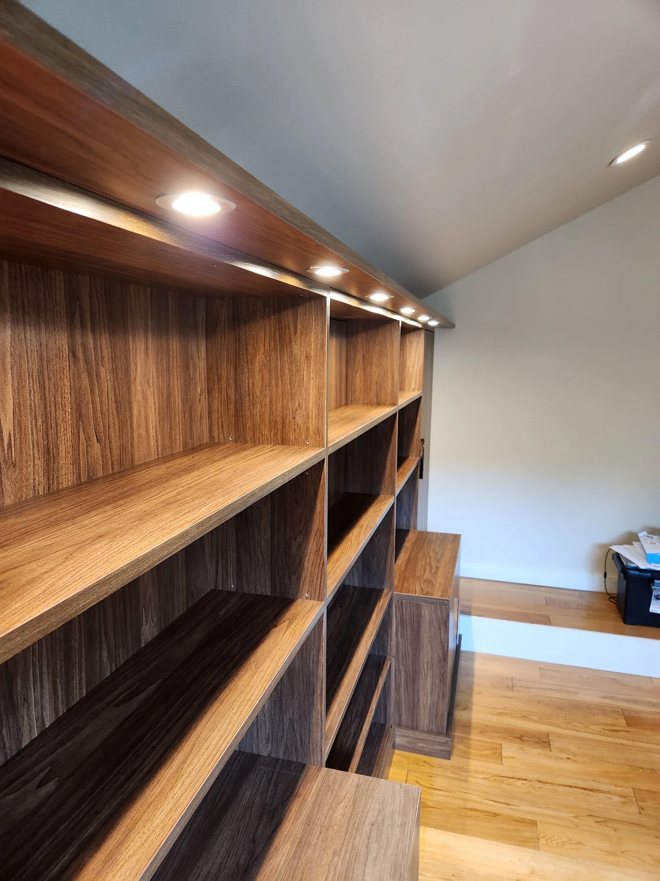 Close view of illuminated library shelving and wood-grain surfaces
