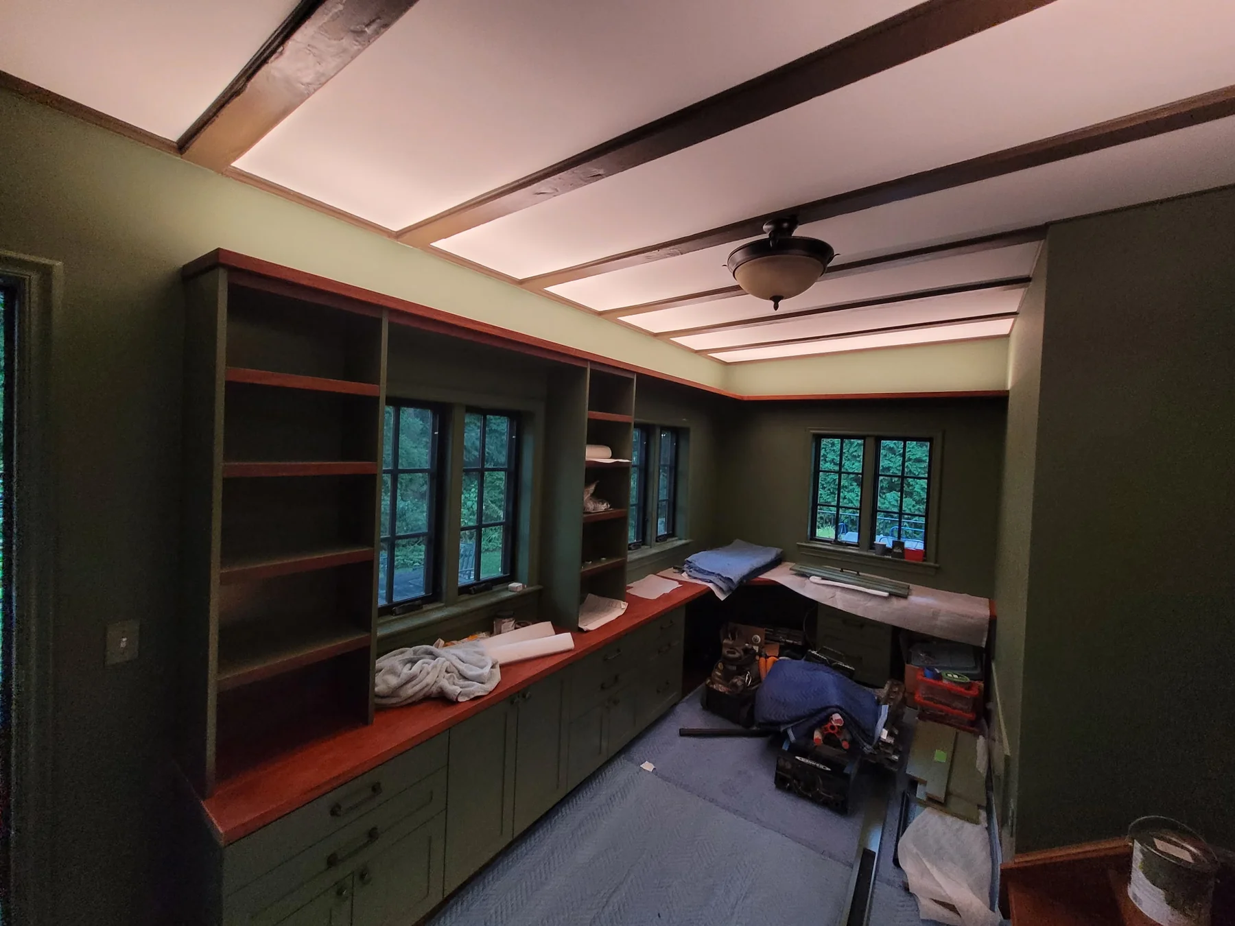 During installation: fitting the olive green office cabinetry while the floor and work surfaces are protected