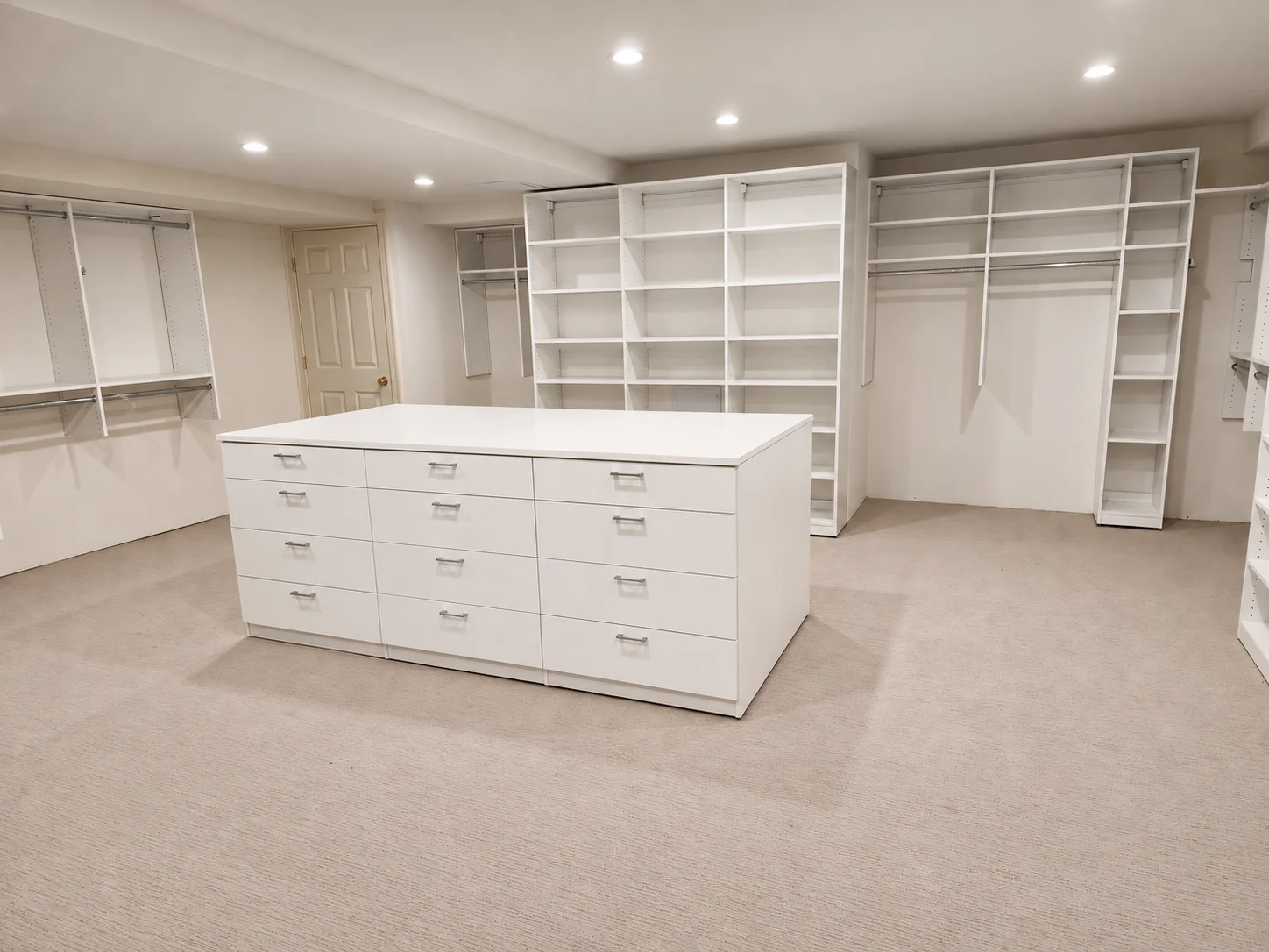 White walk-in closet with a twelve-drawer island, adjustable shelves and hanging rails