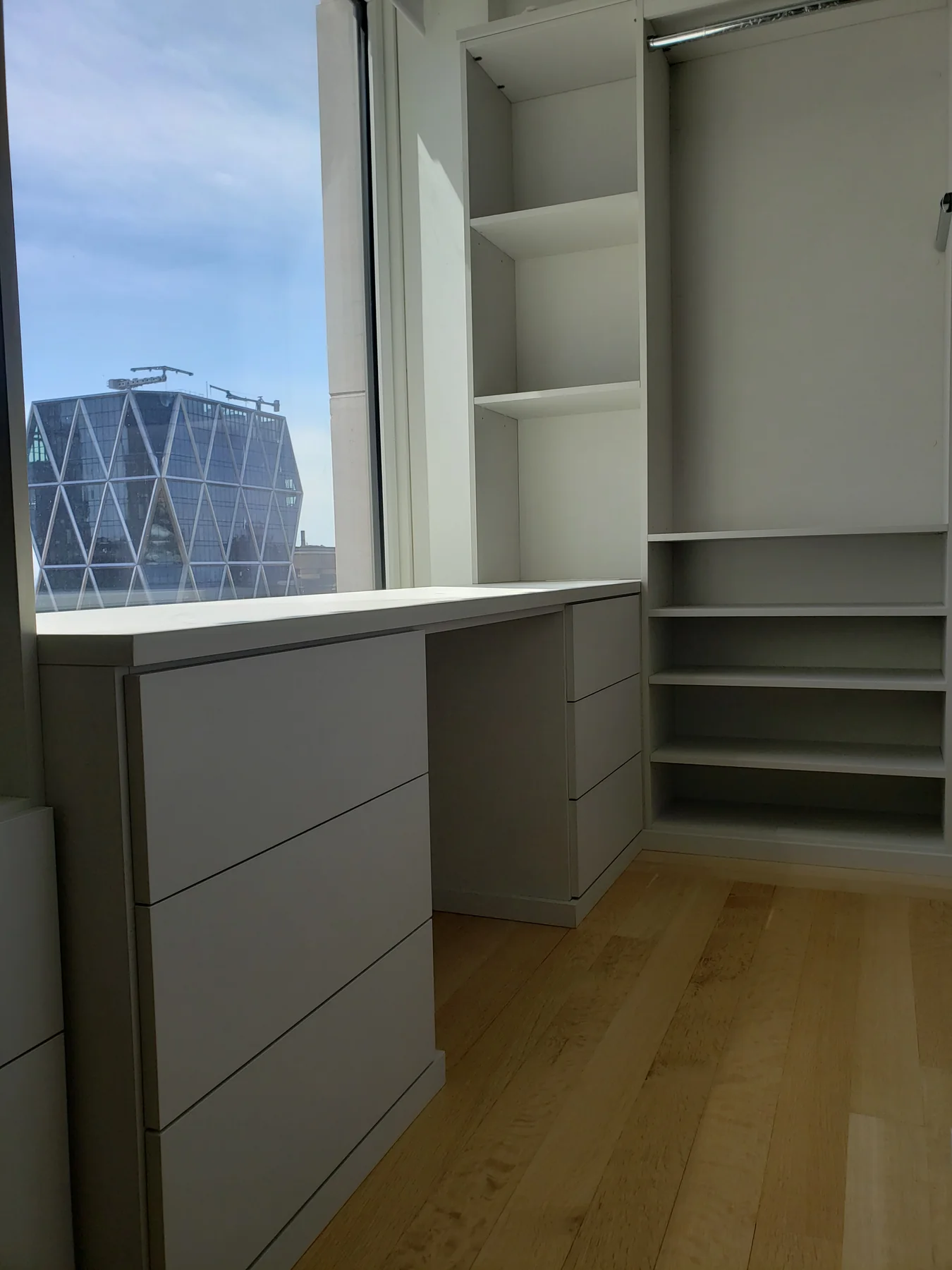 Window-side closet counter with drawer units and adjustable shelving