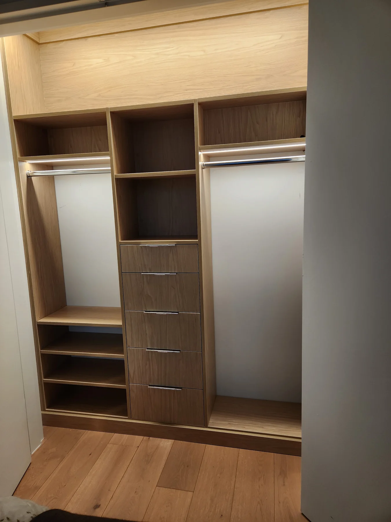 Angled view of the wardrobe drawers, shoe shelves and full-height hanging section